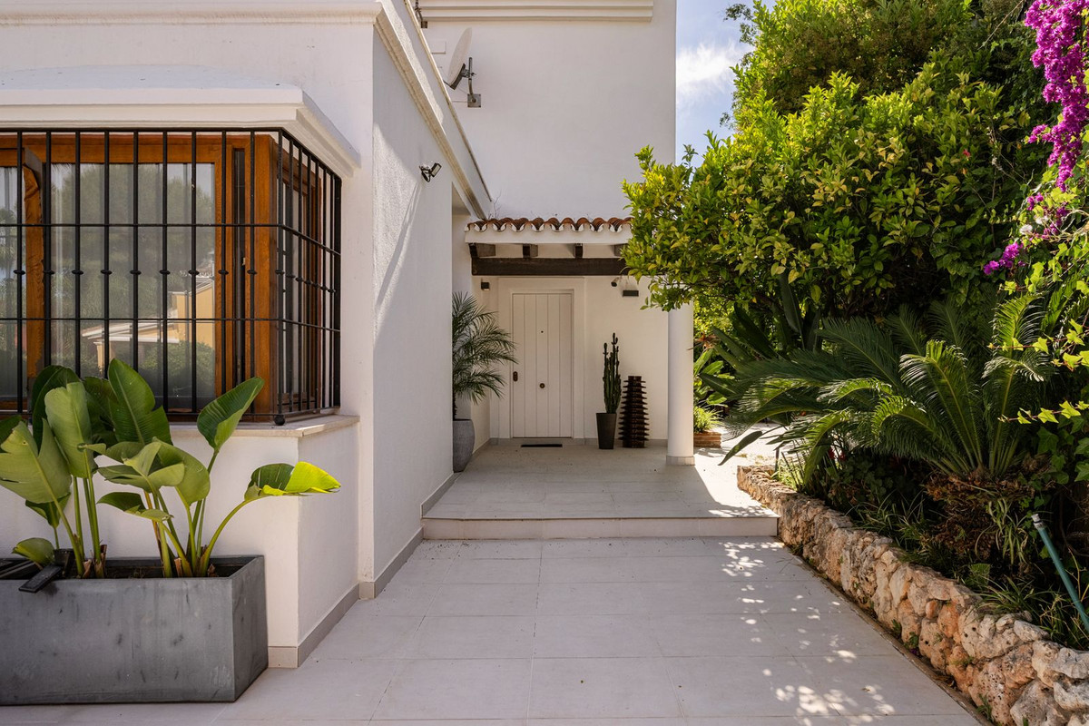 Covered entrance with limestone walkway and planting