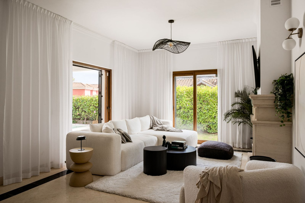 Living room with doors opening to both the pool and the garden