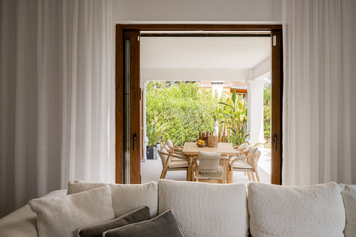 View from the living room out to the covered terrace dining area