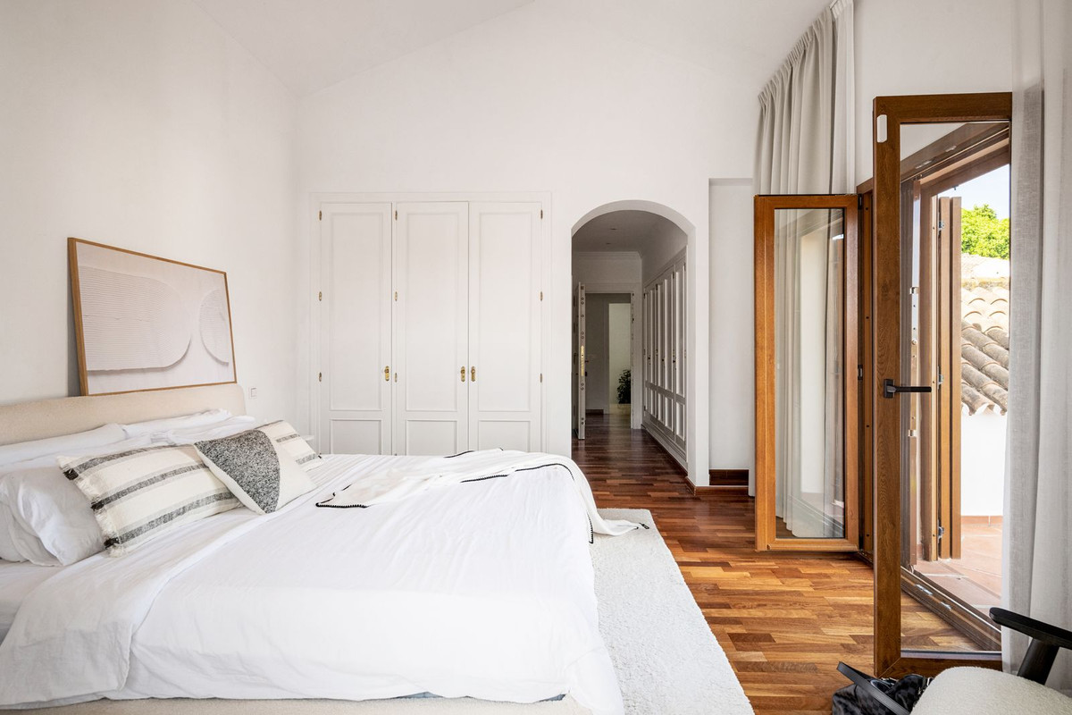 Principal bedroom with fitted wardrobes and terrace access