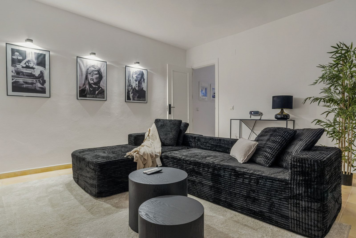 Cinema room with projector, film posters and a deep sofa